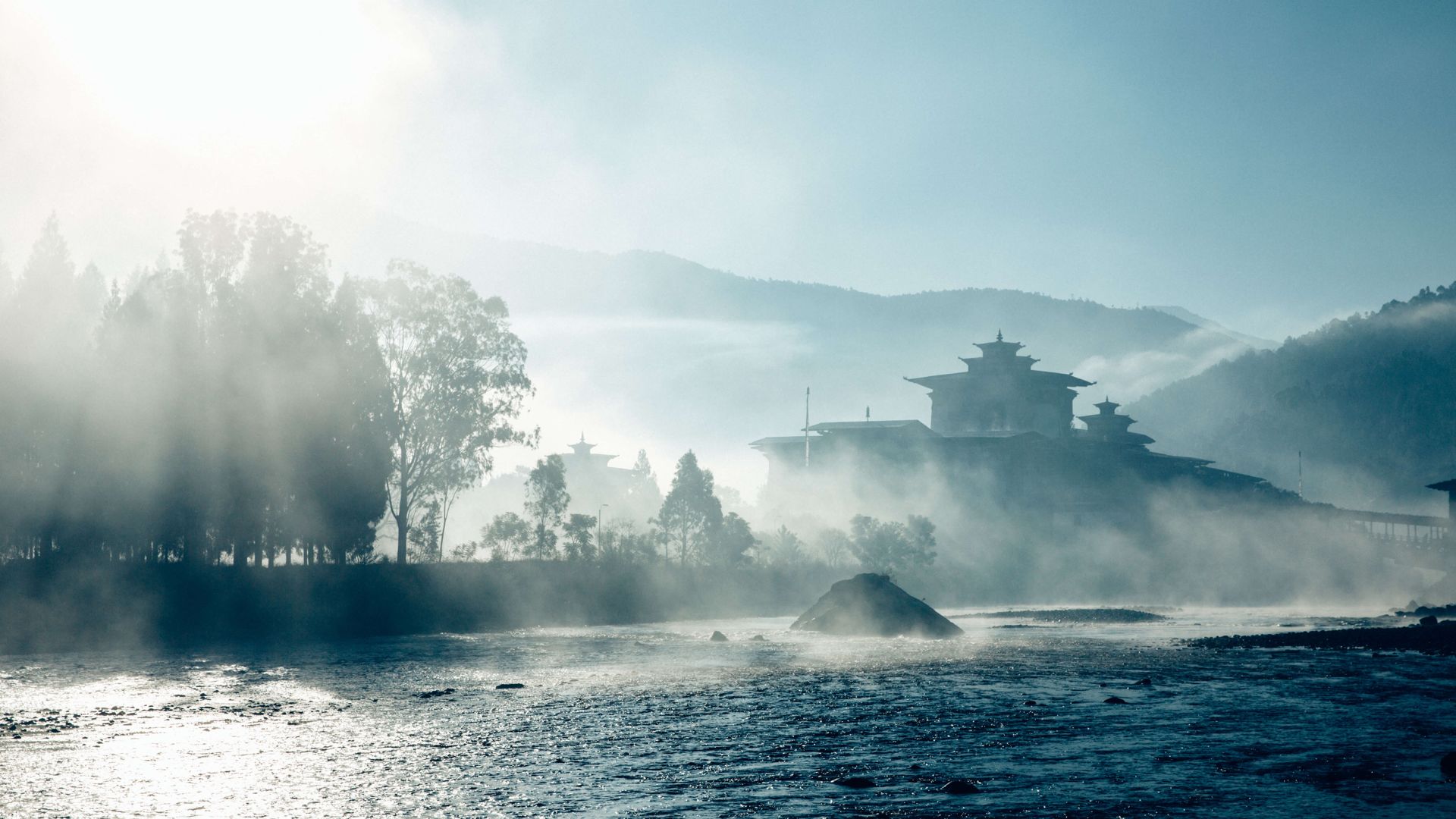 A Building On A Hill Surrounded By Water