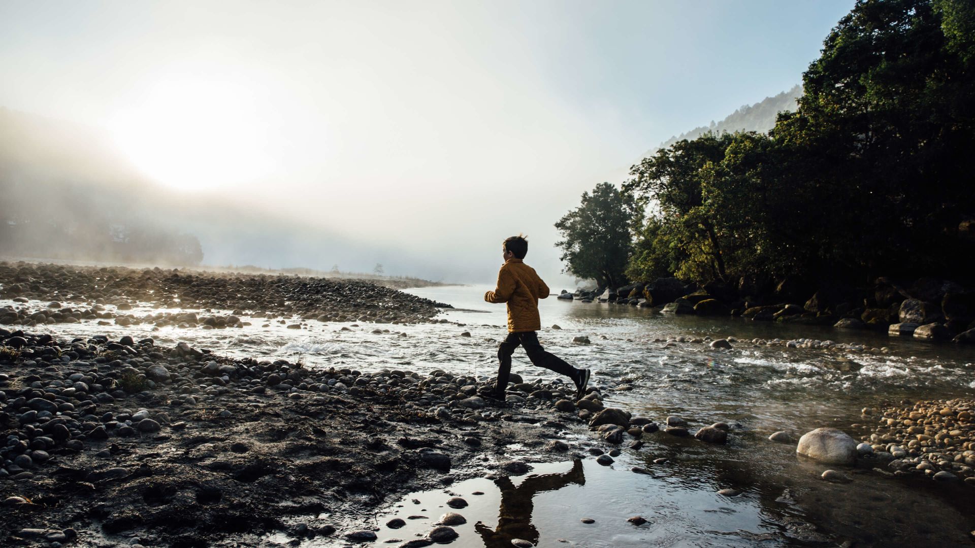 A Man Running On A Rocky Beach