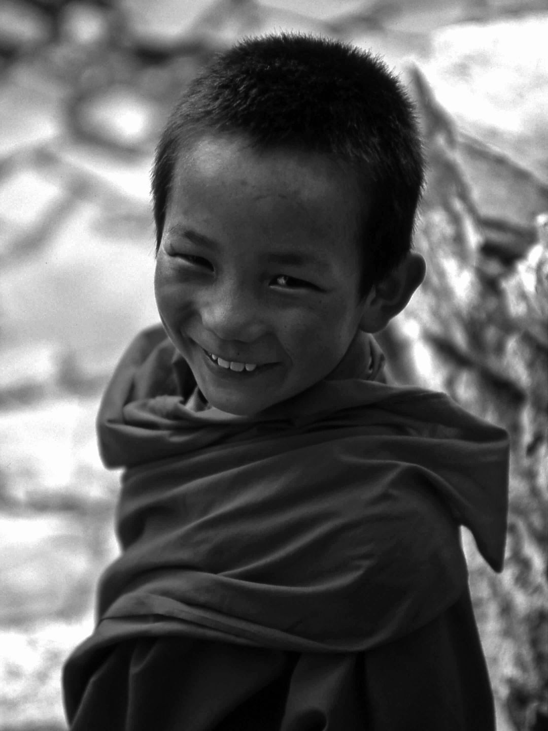 A Boy Smiling And Looking At The Camera