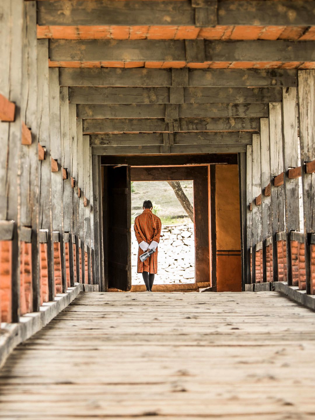 A Person Walking Out Of A Building