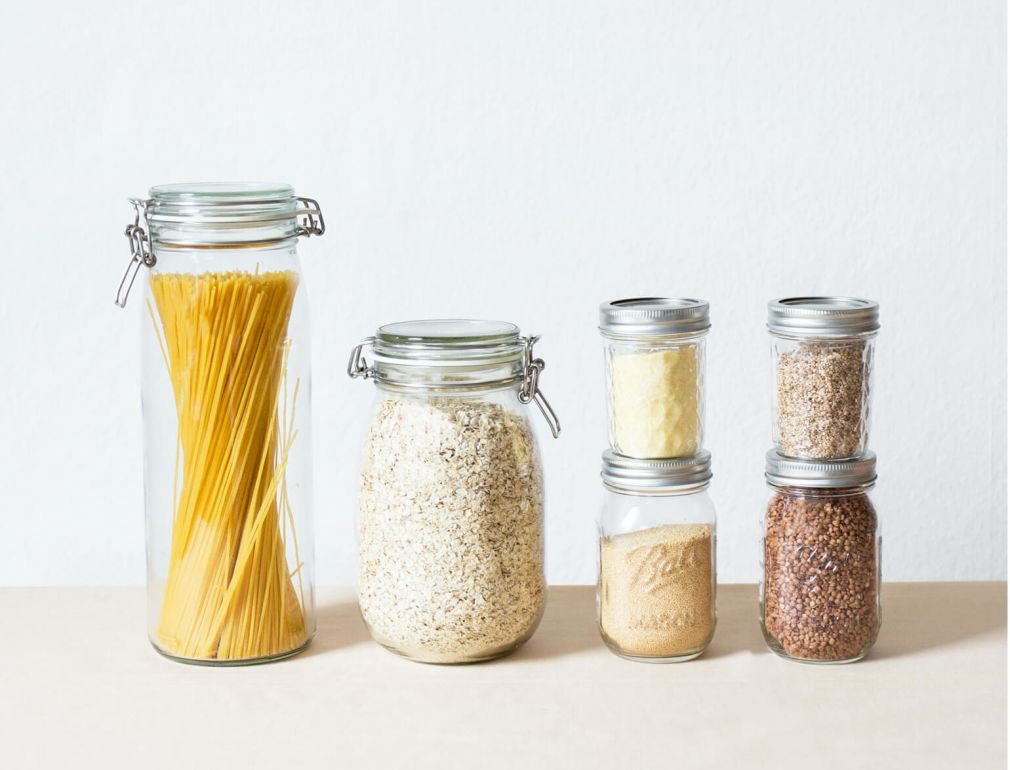 A Group Of Glass Jars With Yellow Liquid In Them