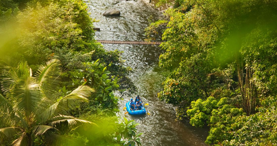 A Group Of People In A Boat On A River