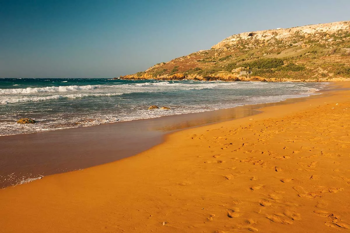 A red sand beach on Gozo