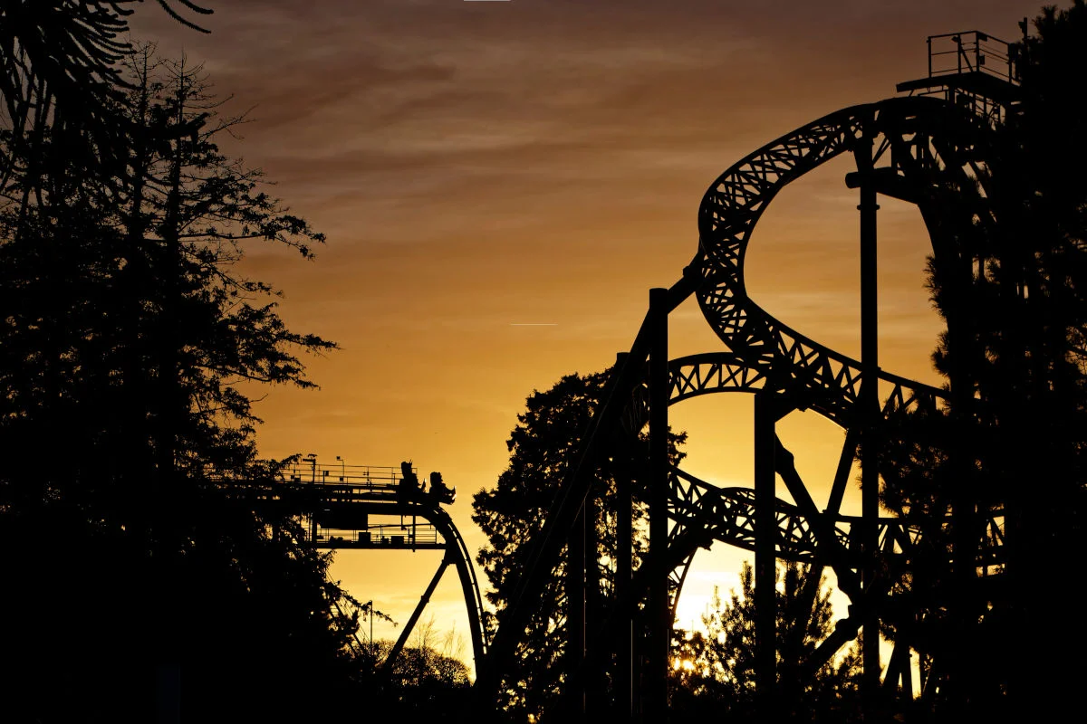 This photograph shows the Oblivion rollercoaster at Alton Towers theme park. It is visible against the backdrop of the setting sun.