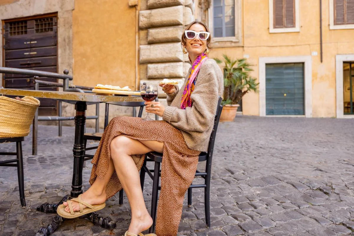Woman eating a meal with a glass of wine © iStock