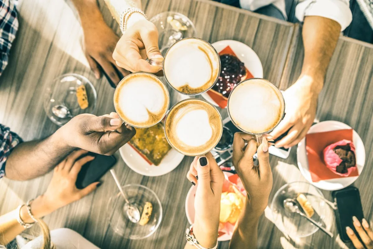 A group of friends over breakfast and traditional milk coffee © iStock